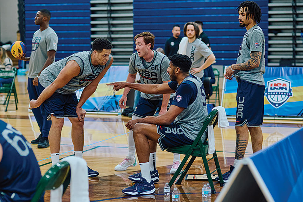 Kareem Maddox, seated, instructs teammates.