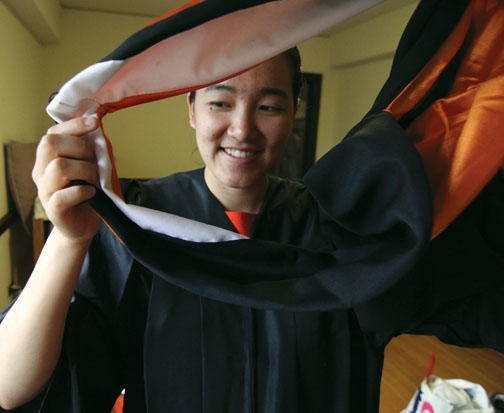 Author Angela Wu ’12 tries on graduation garb.