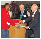 Editor_PrizeRev1.jpg Henry Von Kohorn '66, second from right, assisted by Brian Breuel '66 and Marguerite Vera '79, recognize Princeton Prize winner Sidney Johnson during a race-relations symposium on campus.