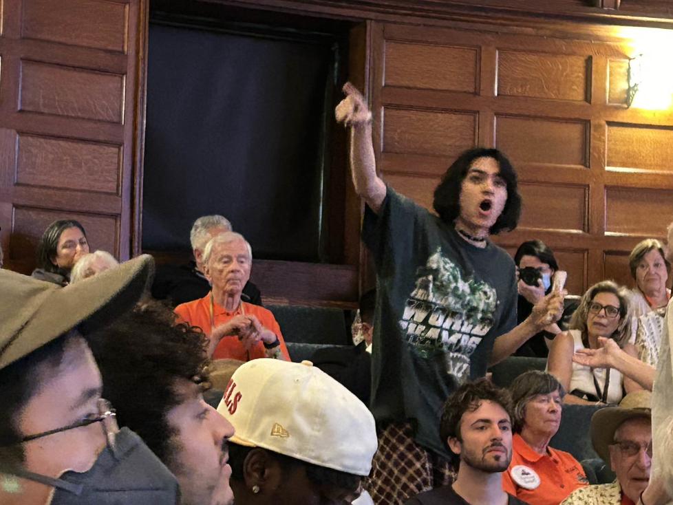 A protester stands and shouts during Eisgruber’s Q&A.