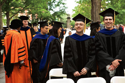 Alexandros A. Ntelekos *08, foreground, left, whose degree was awarded in September; and Spencer E. Quiel *09 watch the proceedings as other Ph.D. recipients file in behind them. Both men were in the Department of Civil and Environmental Engineering.