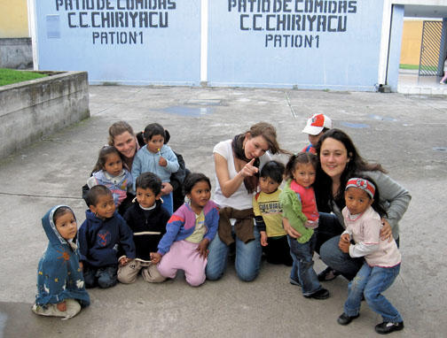 Haley White ’12, right, with students she instructs in an open-air market in Ecuador, and other teachers.