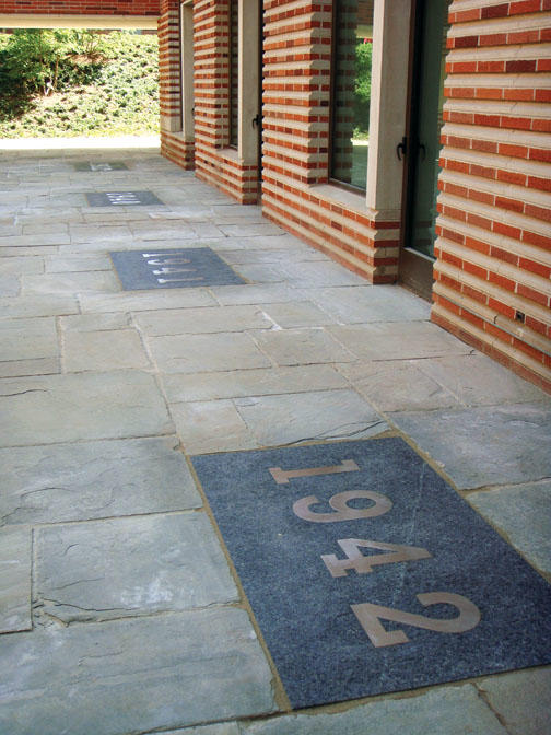 Four plaques recognize the classes for which previous dorms on the site were named.