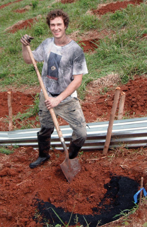 Danny Growald ’11 mixes biochar into the soil on the Osa Peninsula of Costa Rica.