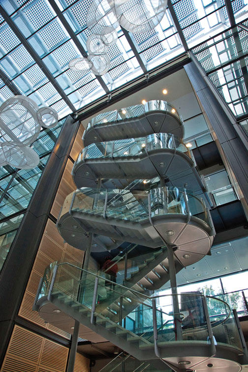 One of two open stairways rises toward the roof, where some of the photovoltaic ­panels are visible.