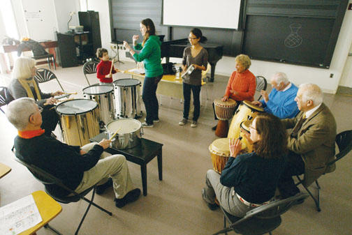 As part of Alumni Day activities, alumni and family members take part in a drum circle led by Frances Cornelius ’10, standing left, and Janet Kim ’10, members of Princeton’s Modern Improvisational Music Appreciation group.