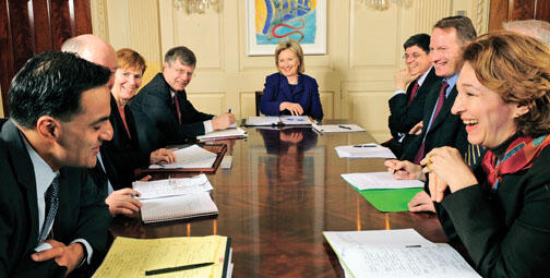 Anne-Marie Slaughter ’80, right, shares a lighter moment at a meeting with Secretary of State Hillary Clinton, ­center, and other foreign-policy staff. At left is assistant secretary Richard Verma. 