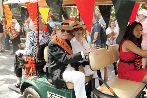 Lou Prince and his wife, Betty, ride along the route at 1941’s 70th.