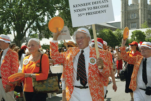 Bill Pelton ’61 and his wife, Louise, prepare to throw Frisbees to children along the route.