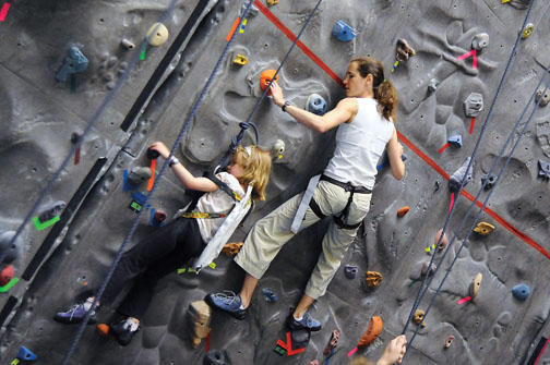 Eleanor Harrison ’92 and daughter Isabelle Harrison Bregman scale the indoor climbing wall at Princeton Stadium