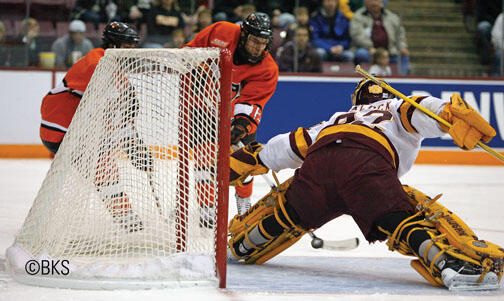 LIVE.SP_MenHockey.jpg Kevin Lohry ’11 shoots against UMD.