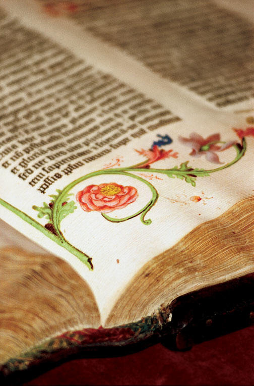 A close-up photograph in “Biblio” captures the vivid colors of the illustrations in the 1455 Gutenberg Bible.