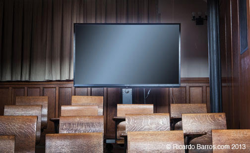 LARGE MONITOR: A movable, 70-inch screen can be set up in the back of the room that allows the lecturer at the podium to see and address both the McCosh audience and those ­conferencing in from another location at the same time. The ­monitor also can fu