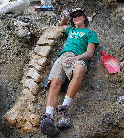 OTC-Dino1.jpg Evan Saitta ’14 at the site of a fossil dig in Montana.