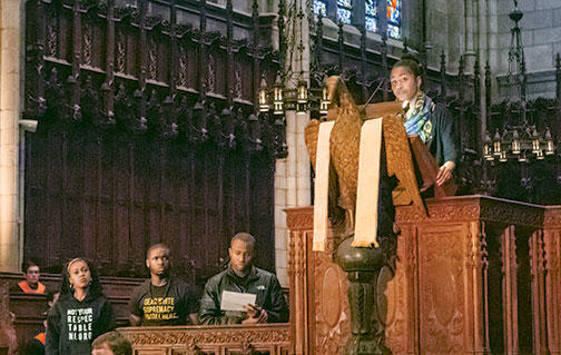 Students read a manifesto during the Chapel gathering; Naimah Hakim ’16 is in the pulpit at upper right.