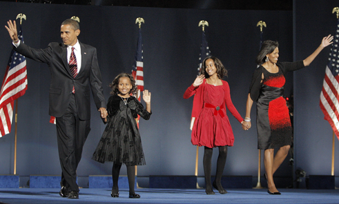President-elect Barack Obama s’85, daughters Malia and Sasha, and first-lady-to-be Michelle Obama ’85 wave to the crowd at an election night rally Nov. 4 in Chicago. A group of black Chicago-area alumni, friends of the Obamas and campaign fund-raisers