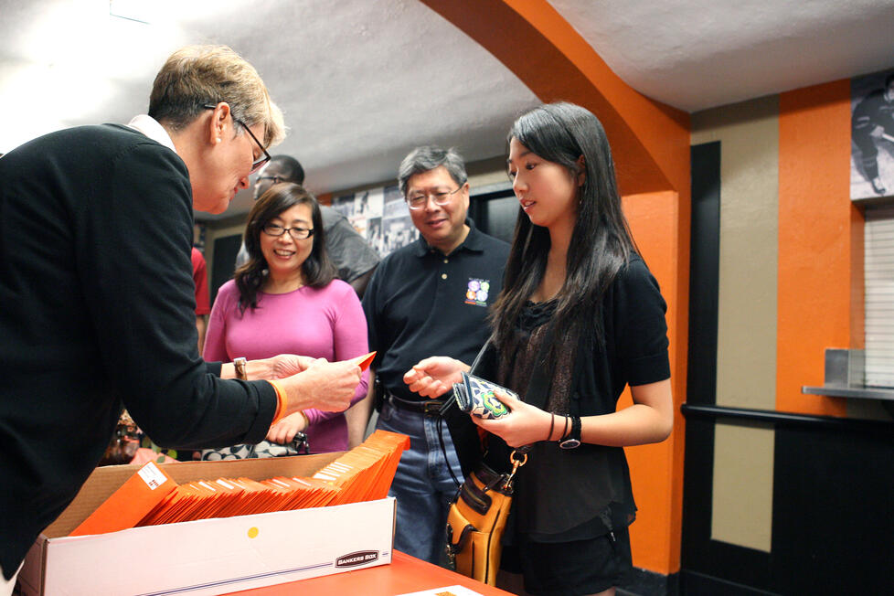 Stephanie Liu '15 receives her check-in package from Amy Campbell of the office of campus life.