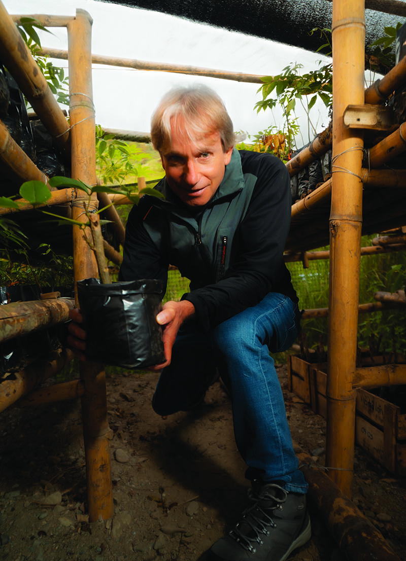 Craig Leon holding a plant.