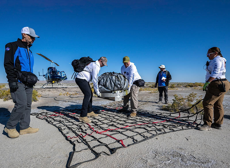 NASA recovery team members prepare the space return capsule