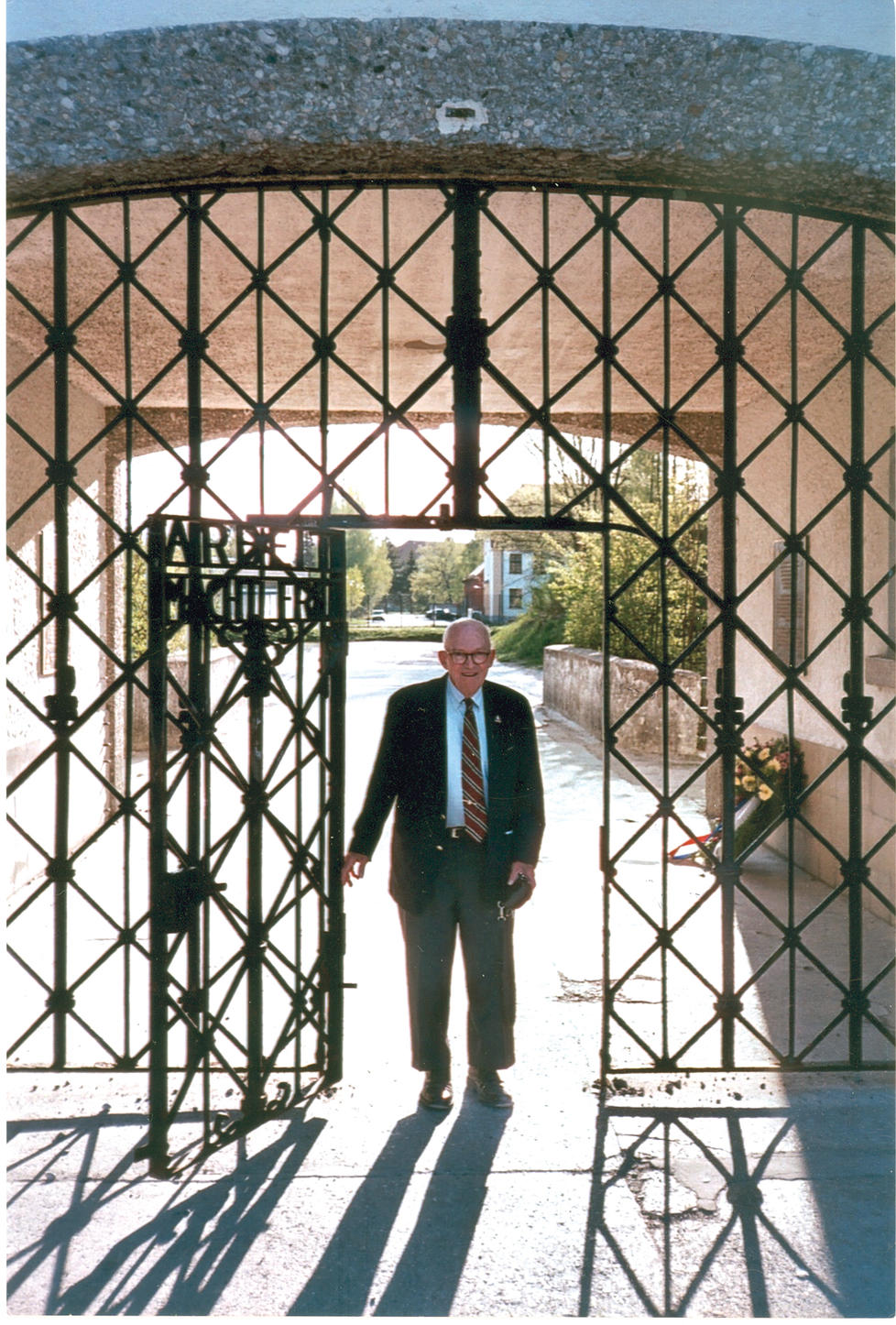 Alan W. Lukens '46 at the main entrance gate to the Dachau concentration camp.