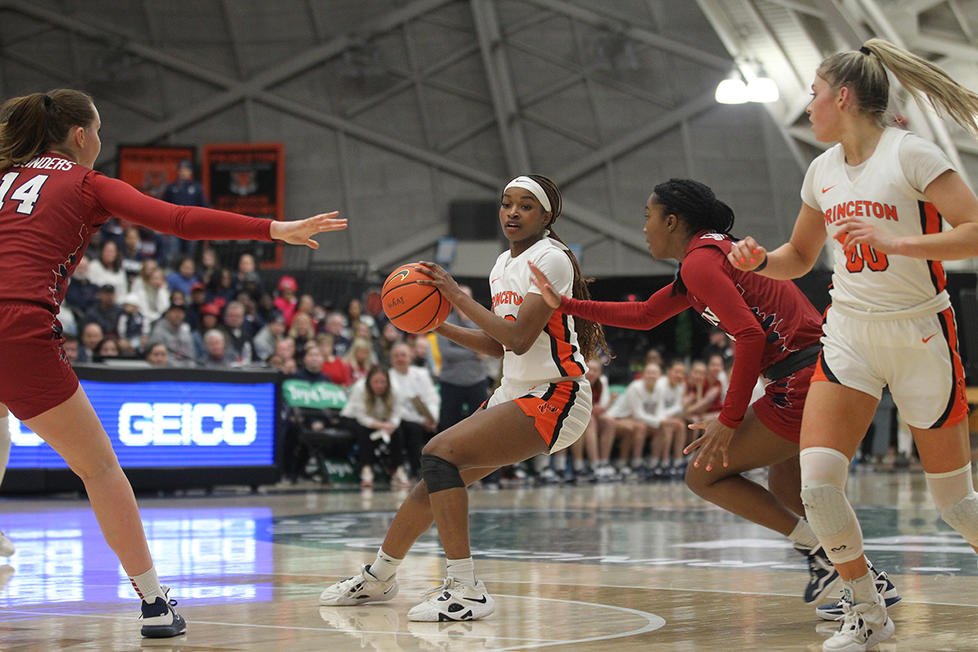 Four women playing basketball during a game.