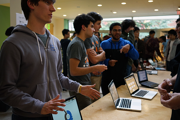 Collin Stedman â15, left, pitches HostShark at the HackPrinceton science fair. (Mary Hui â16/Picture Perfect)