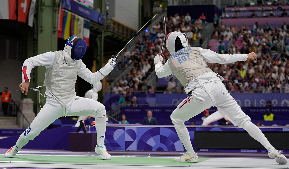 Egypt’s Mohamed Hamza ’23, right, competes with Italy’s Filippo Macchi in the men’s individual foil quarterfinals at the 2024 Summer Olympics at the Grand Palais July 29.