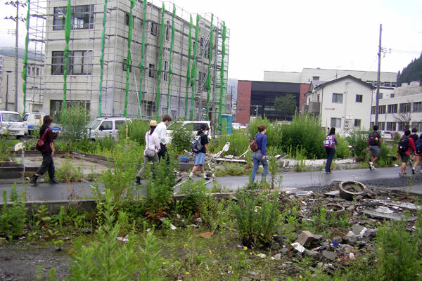 Students walk along a street marked by empty lots and buildings being repaired in Kamaishi, where 20 percent of the city center was inundated by the tsunami.