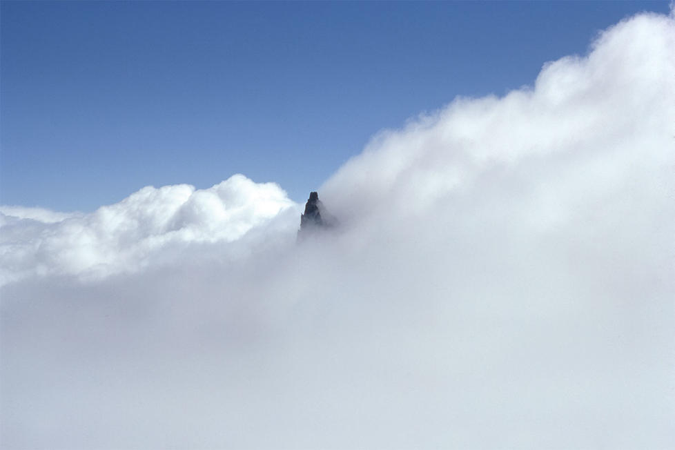  Little Tahoma, a satellite peak of Mount Rainier, poking through the clouds.