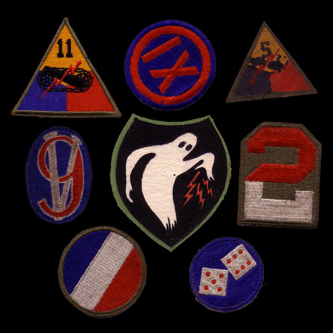 Uniform markings were adopted as well. A sampling of patches worn by Ghost Army members, along with the Ghost Army logo at center.