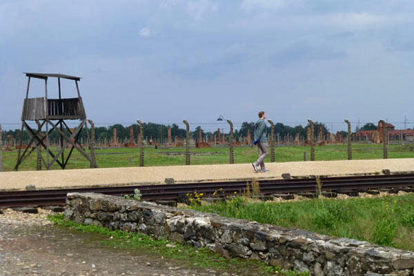 All four of Silberman’s grandparents were Polish Jews. A grandfather, a tailor, survived five Nazi concentration camps. Here, he surveys the Birkenau camp.