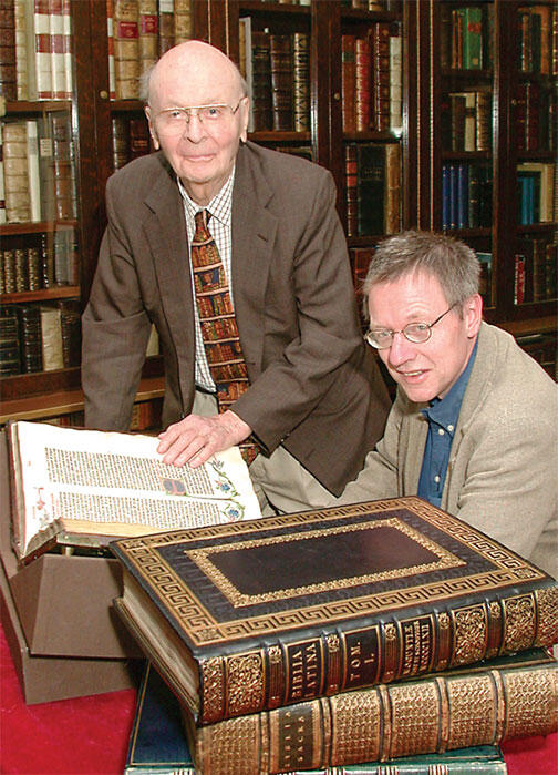 In this 2002 photo, William H. Scheide ’36 (standing) and Scheide Librarian Paul Needham look over some of the first printed editions of the Bible, which are part of the magnificent collection of rare books and manuscripts that now have a permanent home