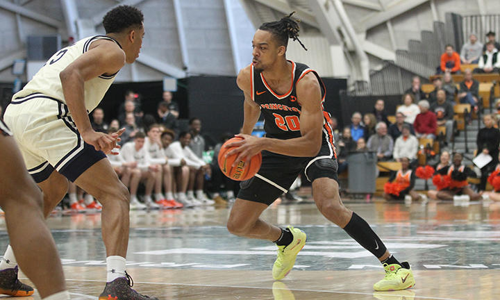 Tosan Evbuomwan dribbles against a Yale defender