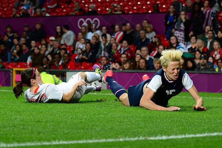 Aug. 6: Canada's Diana Matheson '08, left, and Megan Rapinoe of the United States collide in the women's soccer semifinals. Canada lost in overtime but recovered to win bronze against France on Matheson's 92nd-minute goal.